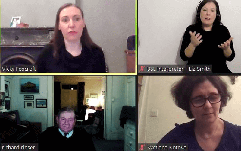 Screen shot of four people in their own homes at a Zoom meeting