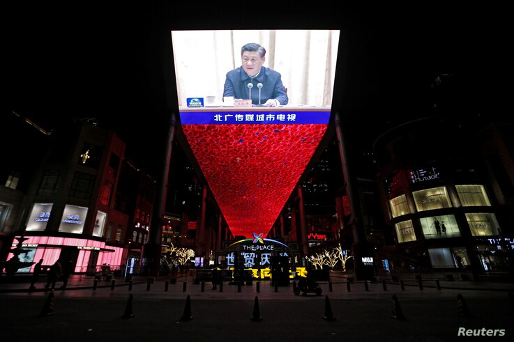 The giant screen shows the state CCTV media broadcasts of Chinese President Xi Jinping in a shopping complex in Beijing