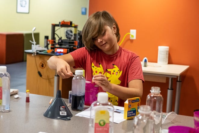 A teenager mixes ingredients at last week's DIY potions event.  The library's summer reading games end on August 1st.  Earn last minute points by attending one of the library events listed.  Don't forget to log your reading and activities at mcpl.info/summerreading.