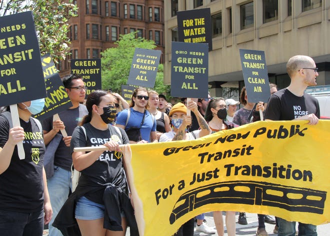 Protesters march along Broad Street towards Scioto Mile during Saturday's Columbus Rally for Public Transit and a Green Future.