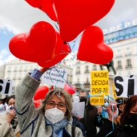 Proponents of a law to legalize euthanasia gather in Madrid as the Spanish parliament votes to approve the procedure in March.  |  REUTERS